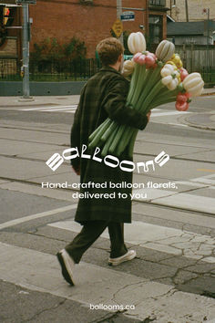 a man walking across a street holding flowers