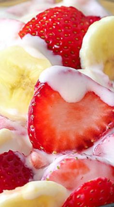 strawberries and bananas are mixed together in a bowl