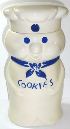 a white cookie jar with blue accents on it