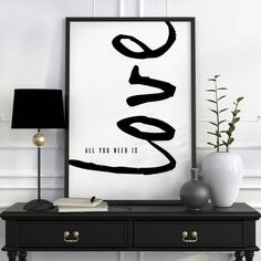 a black and white poster with the word love in cursive writing on it