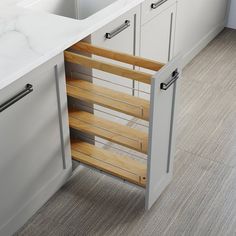 an open cabinet in the middle of a kitchen with marble counter tops and flooring