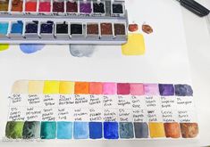 an artist's watercolor palette with the colors in it