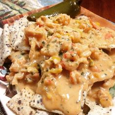 a white plate topped with nachos and cheese