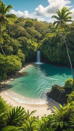 an aerial view of a waterfall in the middle of tropical trees and blue water surrounded by greenery