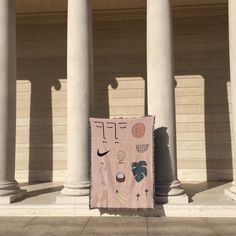 a piece of pink fabric on the ground in front of some pillars