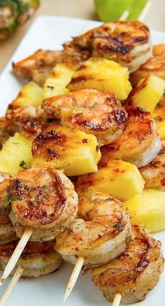 the skewers have pineapples and shrimp on them