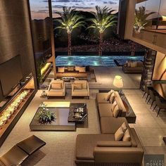 a living room filled with lots of furniture next to a swimming pool