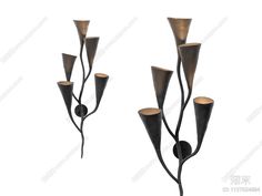 three metal candlesticks with flowers on them