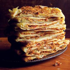 a stack of pancakes sitting on top of a black plate