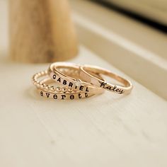 Mother's Day Gift | Personalized stackable ring set, engraved with a name, date, or special word.  Metal: 14k gold filled or fine/sterling silver Dimensions: 2mm tall on average, but our rings are handmade so variations will occur. The birthstone is 2mm on a 1mm band, and the beaded ring is 2 mm. Font: lowercase cursive, uppercase bold block, and lowercase typewriter Unsure what size you need? We highly recommend using our ring sizer for an accurate fit. Some people find that sizing up when stac Rings With Names, Rings Stacked, Stackable Name Rings, Mom Of Three, Stackable Ring Sets, Beaded Ring, Mother Rings, Name Rings, Special Words