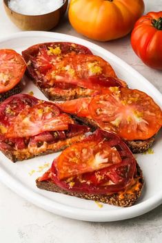 slices of toast with tomatoes on top and other ingredients around it, including an orange pumpkin