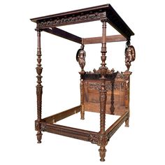 an antique wooden bed with carved headboard and foot board on the sides, sitting against a white background