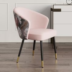 a pink chair sitting on top of a hard wood floor next to a white dresser