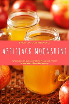 two jars filled with apple cider sitting on top of a table