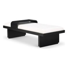 a black and white bench sitting on top of a white floor