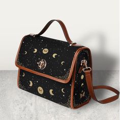 "Cottagecore Celestial Canvas Satchel bag, Kawaii Witch Moon Phases Crossed body vegan leather strap hand bag, goth bag, hippies boho gift >>PRODUCT INFO<< * 18.94 Oz. Made from high-grade waterproof canvas, durable, water-resistant. * Can be used as a nice laptop storage bag, business briefcase, college school bag, leisure travel tote bag, crossbody messenger bag, card wallet case, etc. * Two interior pockets for small items one zipper pocket. * Removable and adjustable shoulder strap. * The sh Things To Buy For High School, Gifts For Goths, Black Bohemian Shoulder Bag With Detachable Strap, Gifts For Hippies, Witch Moon Phases, Cottagecore Items, Goth Bags, Cute Messenger Bag, Witch Bag