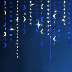 stars and crescents hanging from strings against a blue background