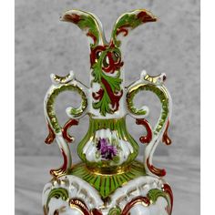 an ornate vase is sitting on a table