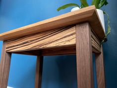 a wooden table with a plant on top