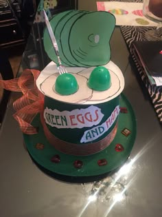 a cake with green eggs on top is sitting on a table