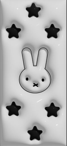 a white rabbit with black stars in the background