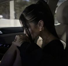 a woman sitting in the back seat of a car