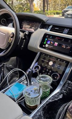 the interior of a car with various items on display in front of it and an electronic device attached to the dash board