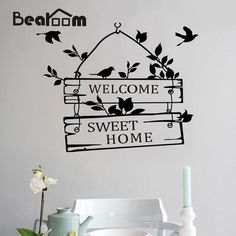 a wall decal that says welcome to sweet home with birds flying over the sign