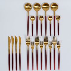 a group of gold and red forks and spoons