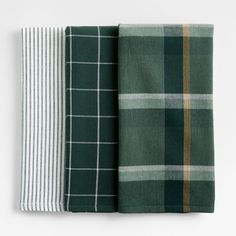 three different plaid napkins on top of each other, one in green and the other in white