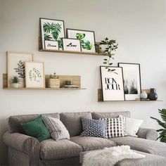 a living room filled with furniture and framed pictures on the wall above it's couch