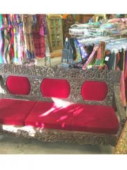 a red couch sitting in front of a store