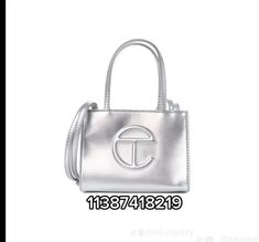 an image of a silver handbag with the letter t on it's side