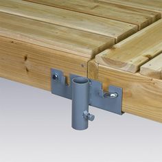 a close up of a wooden bed frame with two metal brackets on the top and bottom