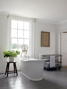 a white bath tub sitting next to a window