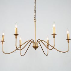 a chandelier with six lights hanging from it's center and four arms