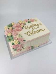 a baby and bloom cake with flowers on it