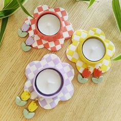 three tea cups sitting on top of a wooden table