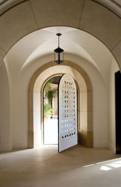 an arched doorway with a light hanging from the ceiling