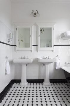 a black and white bathroom with two sinks