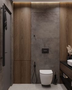 a bathroom with a toilet, sink and shower in the corner next to a wall mounted faucet