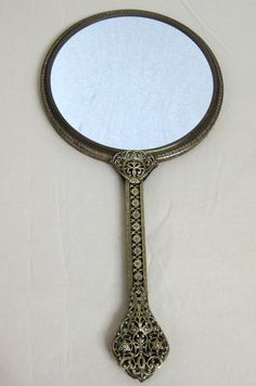 an antique looking mirror is hanging on the wall