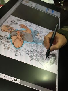 a person is drawing on a large sheet of paper