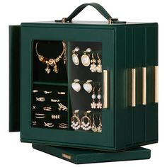 a green box with many different types of jewelry in it's display case on a white background