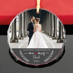 a glass ornament with a photo of a bride and groom