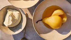 two plates with desserts on them and spoons next to each other in bowls