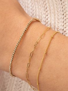 The perfect layering bracelet is dainty and simple — like our Satellite Layering Bracelet! The classic chain goes with any style, and the delicate size fits in with any stack. If your wrist is in need of another layering piece, you've just found it. Bracelet Rosary, Pyrite Bracelet, Layered Bracelet, Everyday Bracelet, Bracelet Bead, Bracelet Dainty, Dainty Bracelet, Rosary Chain, Bead Chain