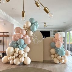 balloons are arranged in the shape of letters and numbers on top of a table with chairs