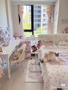 a cat is sitting on the edge of a bed in a room with many stuffed animals