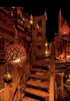 the stairs are decorated with decorative items and lights in arabic writing on wood planks